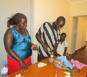 Midwives practice bag-and-mask resuscitation skills during Master Trainer training, 2013